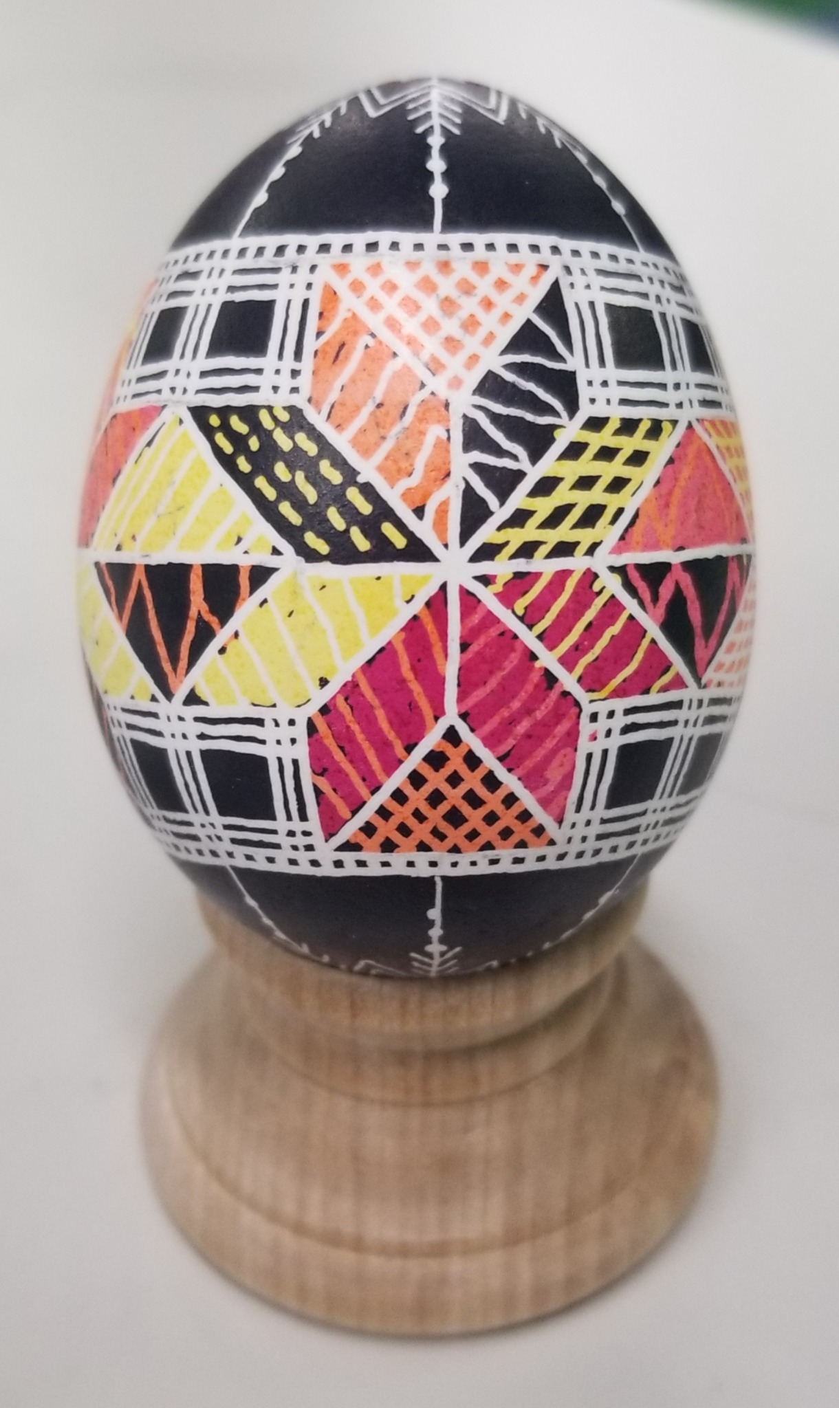 Completed Inscribe game egg with a rule-based game-board design wrapped around the egg surface.